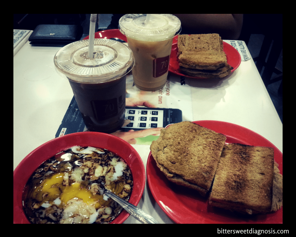 Traditional breakfast in Singapore - 2 soft boiled eggs, kaya (coconut egg jam) and butter on (3 stacks of) toast.